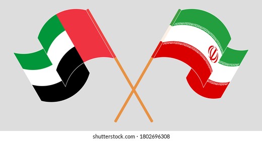 Crossed and waving flags of Iran and United Arab Emirates