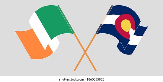 Crossed and waving flags of Ireland and The State of Colorado