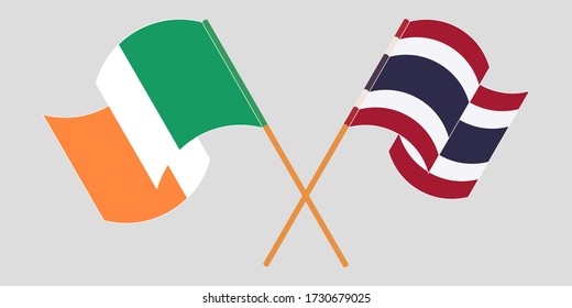 Crossed and waving flags of Ireland and Thailand
