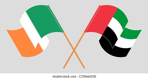 Crossed and waving flags of Ireland and the United Arab Emirates