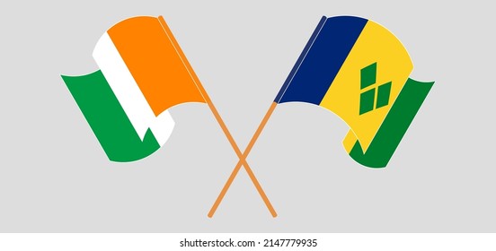 Crossed and waving flags of Ivory Coast and Saint Vincent and the Grenadines. Vector illustration
