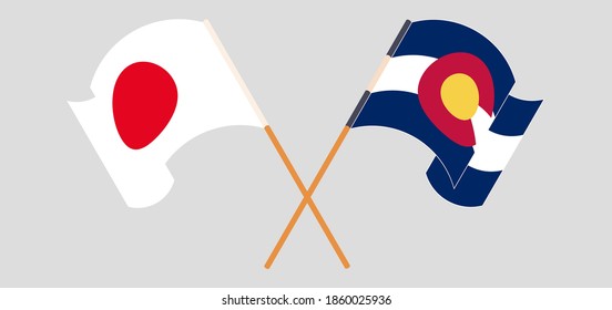 Crossed and waving flags of Japan and The State of Colorado