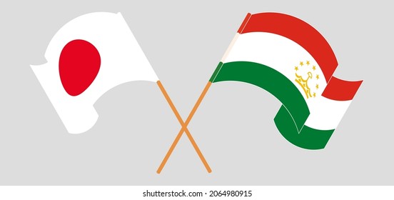 Crossed and waving flags of Japan and Tajikistan