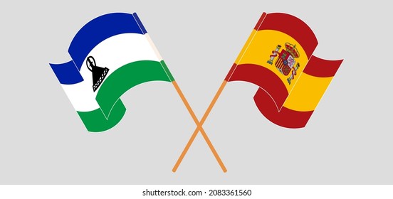 Überquerte und schwellende Flaggen des Königreichs Lesotho und Spaniens. Vektorgrafik
