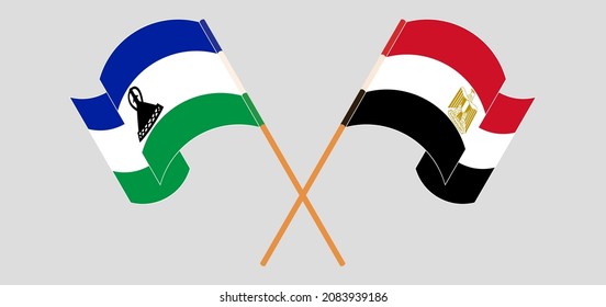 Crossed and waving flags of Kingdom of Lesotho and Egypt. Vector illustration
