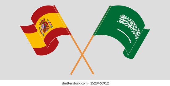 Crossed and waving flags of the Kingdom of Saudi Arabia and Spain