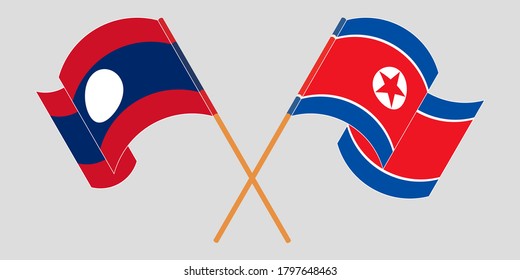 Banderas cruzadas y ondeando banderas de Laos y Corea del Norte