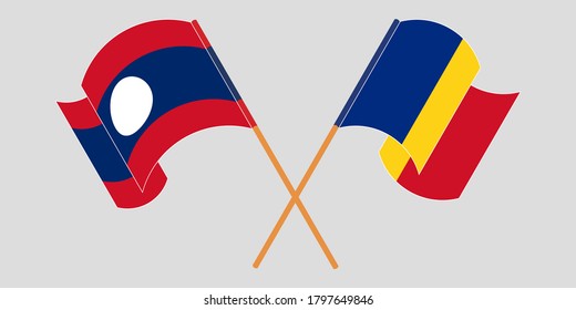 Crossed and waving flags of Laos and Romania