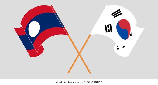 Crossed and waving flags of Laos and South Korea