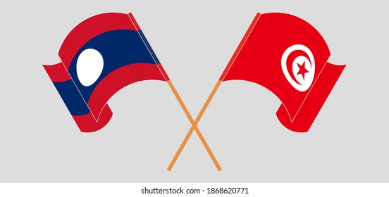 Crossed and waving flags of Laos and Tunisia
