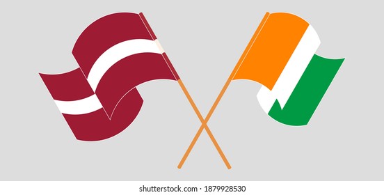 Crossed and waving flags of Latvia and Republic of Ivory Coast