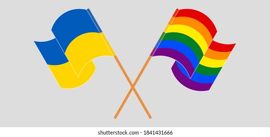 Crossed and waving flags of LGBTQ and the Ukraine