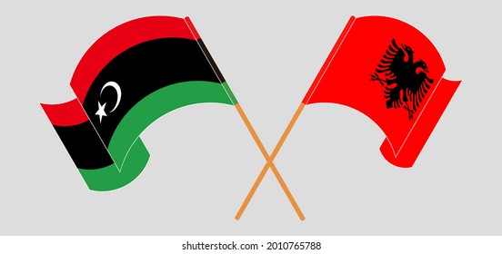 Crossed and waving flags of Libya and Albania