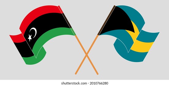 Crossed and waving flags of Libya and the Bahamas