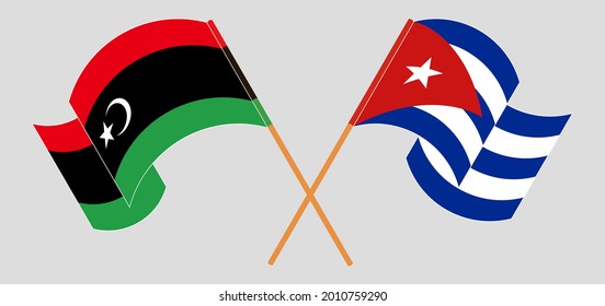 Crossed and waving flags of Libya and Cuba