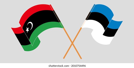 Crossed and waving flags of Libya and Estonia