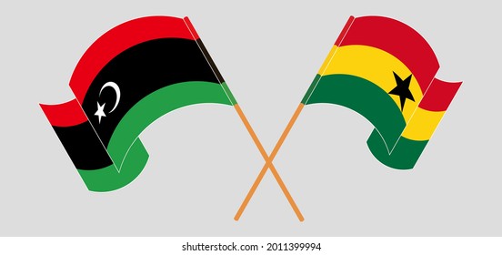 Crossed and waving flags of Libya and Ghana
