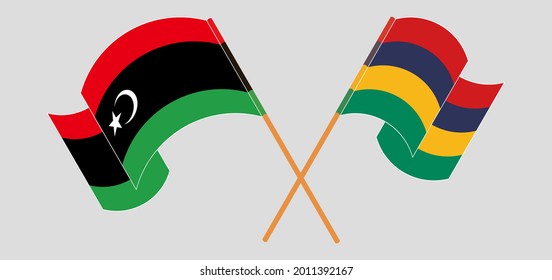 Crossed and waving flags of Libya and Mauritius