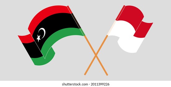 Crossed and waving flags of Libya and Monaco