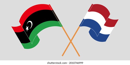 Banderas cruzadas y ondeando banderas de Libia y los Países Bajos