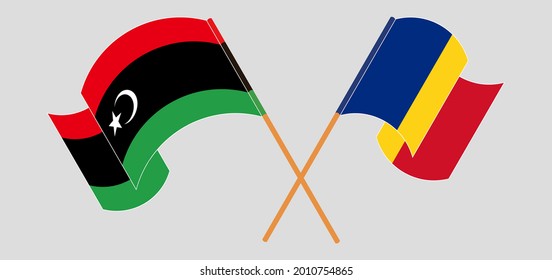 Crossed and waving flags of Libya and Romania