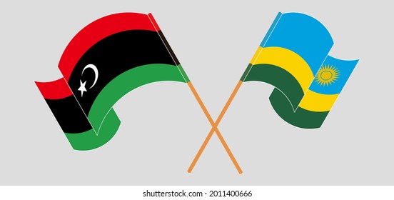 Crossed and waving flags of Libya and Rwanda