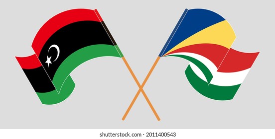 Crossed and waving flags of Libya and Seychelles
