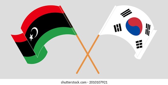 Crossed and waving flags of Libya and South Korea