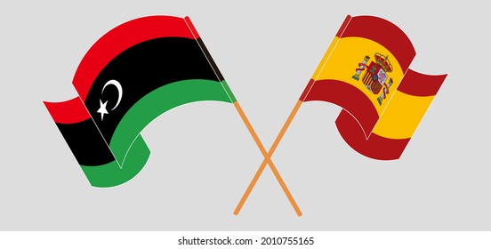 Crossed and waving flags of Libya and Spain