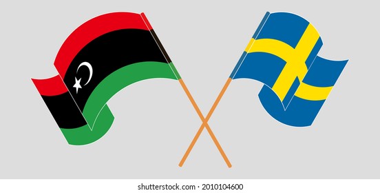 Crossed and waving flags of Libya and Sweden
