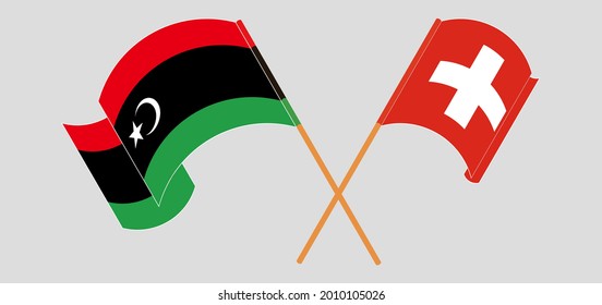 Banderas cruzadas y ondeando banderas de Libia y Suiza
