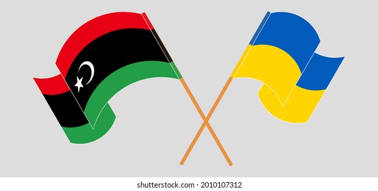 Gekreuzte und wehende Flaggen Libyens und der Ukraine