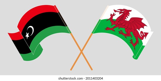 Crossed and waving flags of Libya and Wales