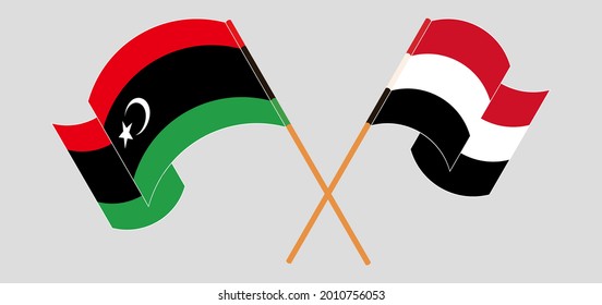 Crossed and waving flags of Libya and Yemen