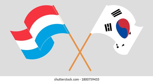 Crossed and waving flags of Luxembourg and South Korea