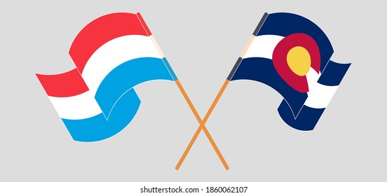 Crossed and waving flags of Luxembourg and The State of Colorado