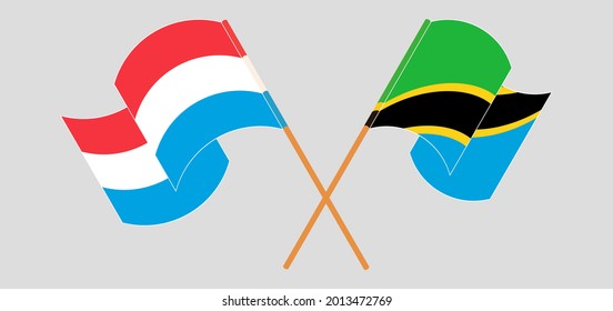 Crossed and waving flags of Luxembourg and Tanzania