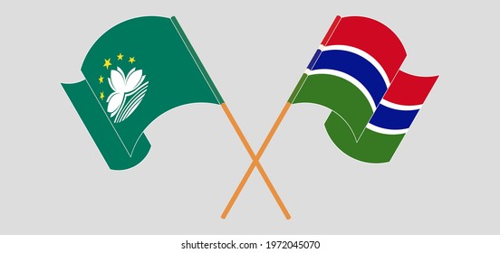 Crossed and waving flags of Macau and the Gambia