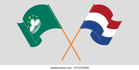 Crossed and waving flags of Macau and the Netherlands