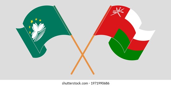 Crossed and waving flags of Macau and Oman