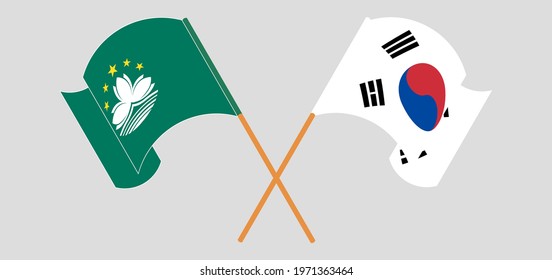 Crossed and waving flags of Macau and South Korea
