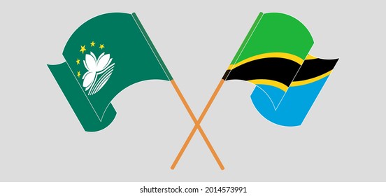 Crossed and waving flags of Macau and Tanzania