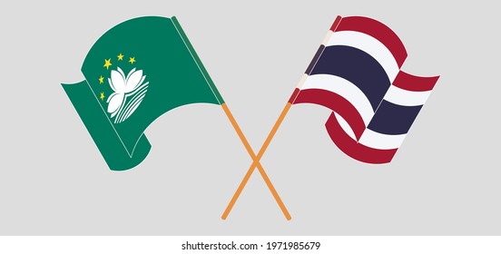 Crossed and waving flags of Macau and Thailand