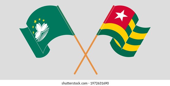 Crossed and waving flags of Macau and Togo