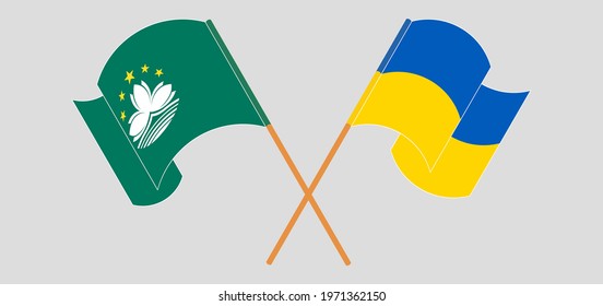 Crossed and waving flags of Macau and Ukraine