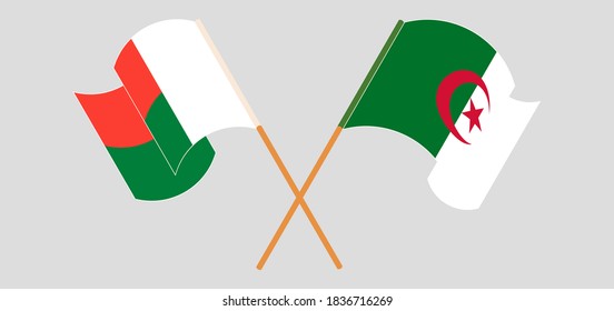 Crossed and waving flags of Madagascar and Algeria