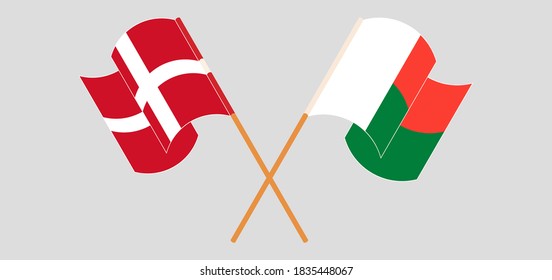 Crossed and waving flags of Madagascar and Denmark. Vector illustration
