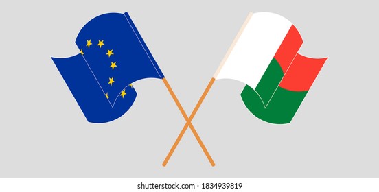 Banderas cruzadas y ondeando banderas de Madagascar y la Unión Europea. Ilustración del vector
