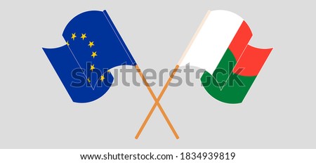 Crossed and waving flags of Madagascar and the EU. Vector illustration
