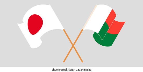Crossed and waving flags of Madagascar and Japan. Vector illustration
